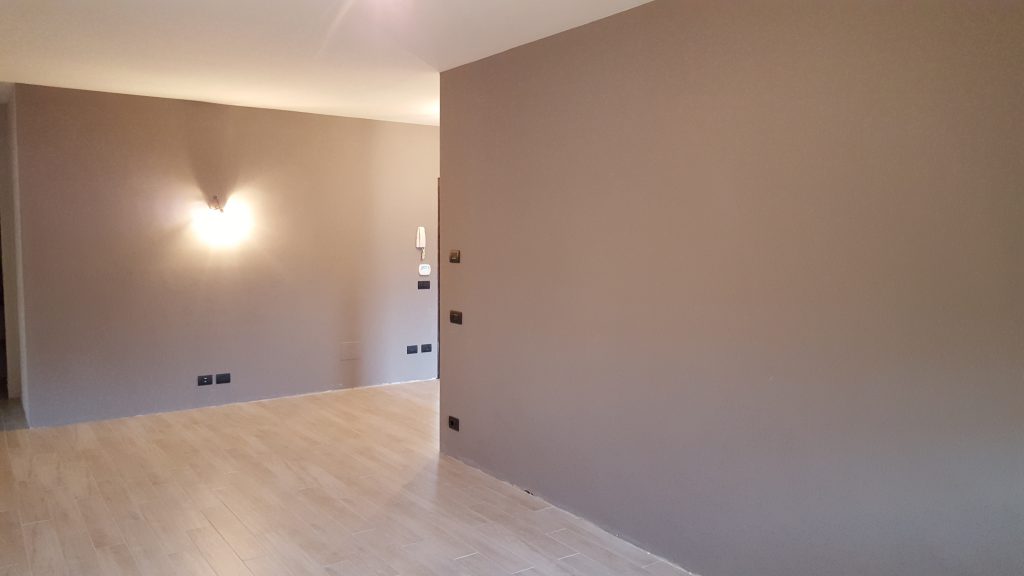 ristrutturazione di un appartamento a parma: Sala con parquet e muri dai gradienti caldi Parma